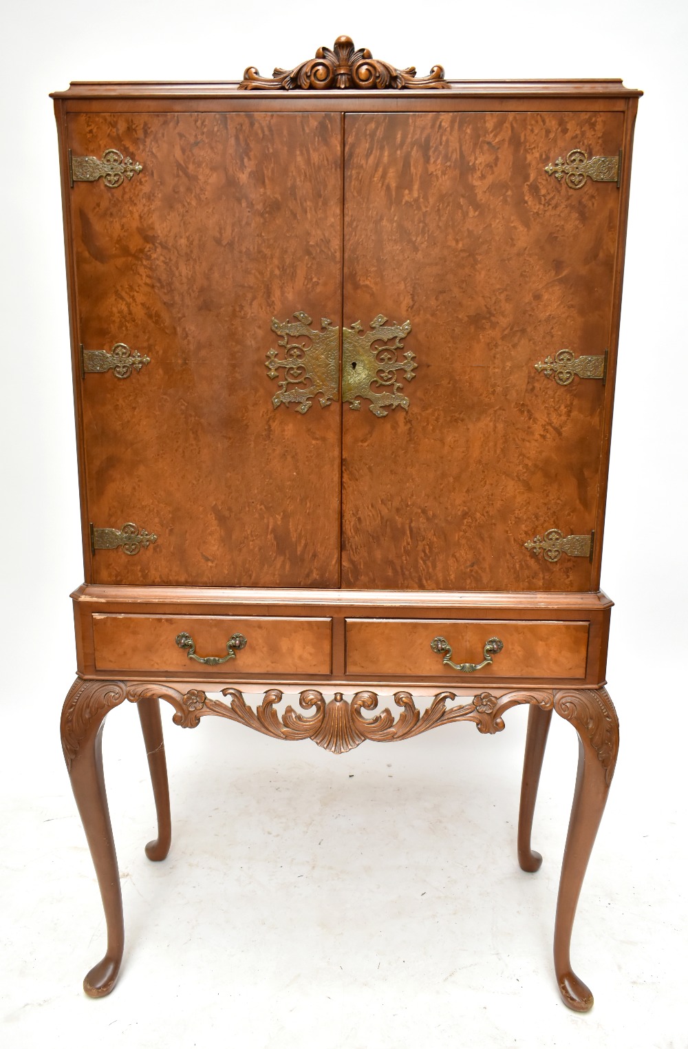 A mid-20th century burr walnut veneered Epstein style cocktail cabinet with twin doors enclosing