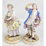 A pair of late 19th century Continental porcelain figures of a dandy and his companion, both