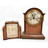 An Edwardian oak and boxwood strung eight day mantel clock, the circular silvered dial set with