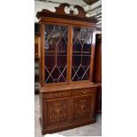 An Edwardian inlaid mahogany bookcase, the upper section with twin astragal glazed doors above two