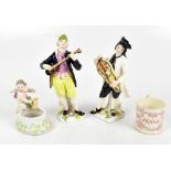 A pair of early 20th century hard paste porcelain figurines depicting musicians, unsigned, height