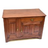 A walnut cupboard featuring linenfold detail with single drawer and two doors on bracket feet,