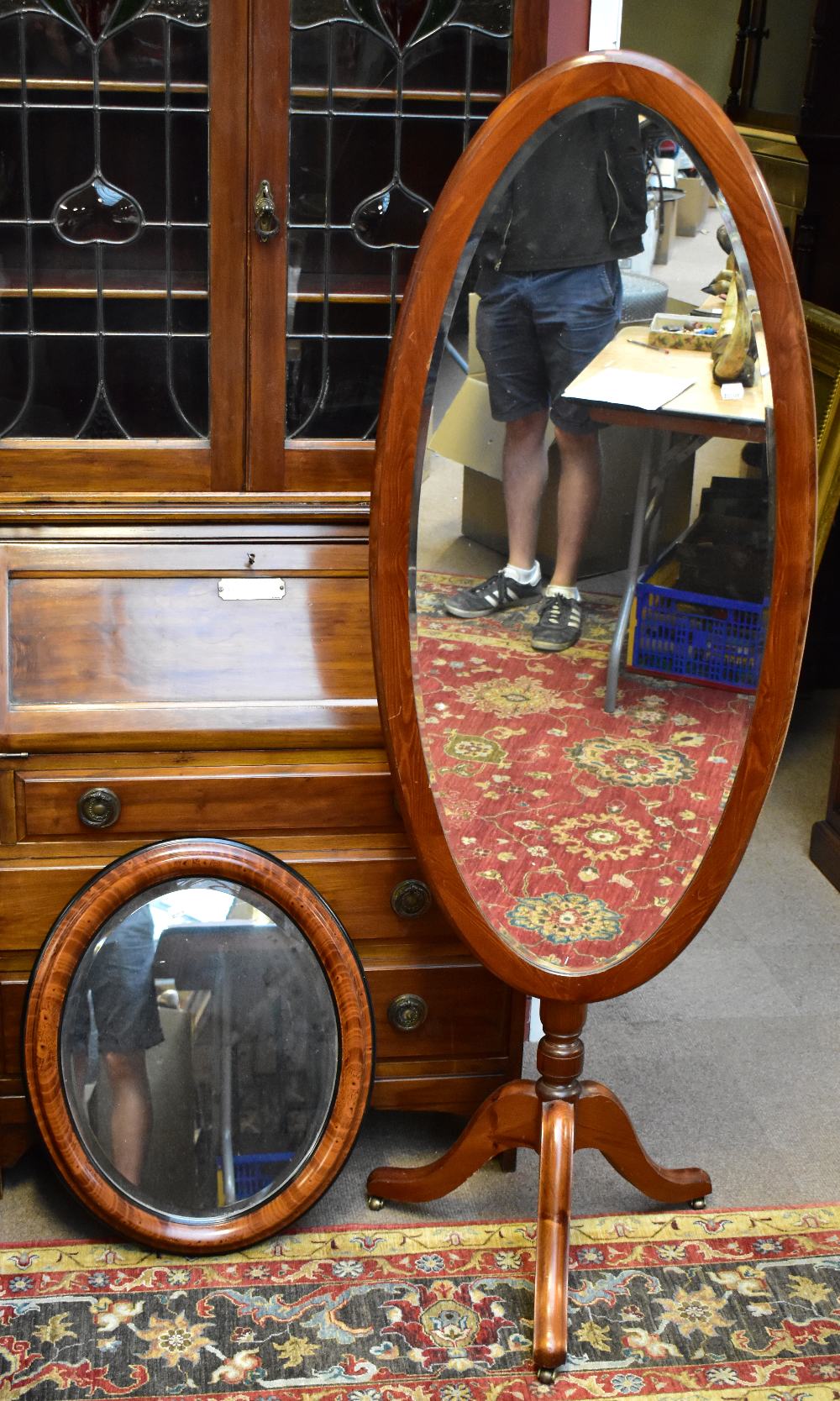 A stained pine cheval mirror, height 163cm, width 53cm, and a wall mirror (2).