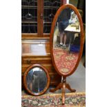 A stained pine cheval mirror, height 163cm, width 53cm, and a wall mirror (2).