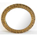 An early 20th century gilt framed oval wall mirror with bevelled plate, 68 x 77cm.