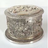 A Victorian oval silver plated biscuit box with repoussé decoration of cavorting cherubs in