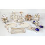 A group of silver plated items including egg stands, a three piece cruet set with cast decoration
