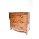 An early 19th century inlaid mahogany bowfront chest of three drawers, raised on bracket feet,