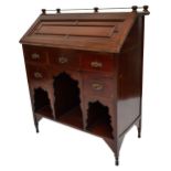 ATTRIBUTED TO LIBERTY & CO; a 19th mahogany bureau with brass gallery above fielded fall-front
