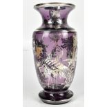 An early 20th century amethyst glass vase with white metal foliate motif overlay, unsigned and