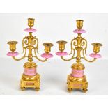 A pair of late 19th century gilt metal and porcelain twin branch cassolettes raised on gilt metal