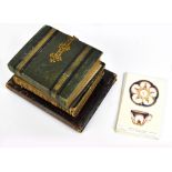 Three 19th century leather bound vacant photograph albums, two with brass mounts and tooled