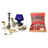A cased canteen of silver plated cutlery and further items to include flatware, candlesticks, etc.