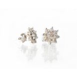 A cased pair of 18ct white gold diamond flower cluster earrings.