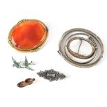 A yellow metal framed carnelian brooch, a silver bird-form brooch, a hallmarked silver brooch, etc.