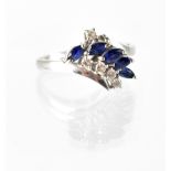 An 18ct white gold diamond and sapphire cross-over ring,