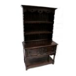 A 19th century oak dresser of small proportions, carved frieze above two plate racks,