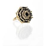 A 9ct gold diamond and black stone cluster ring, the cluster set over four tiers, size L/M,