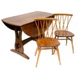 An Ercol c1970s seven-piece elm and beech dining suite comprising drop-leaf dining table with slab