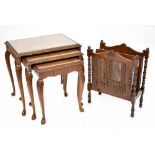 A reproduction walnut nest of tables with glass tops,