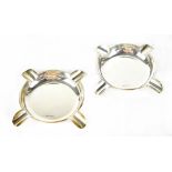 A pair of George V hallmarked silver cigar ashtrays of circular form, each with four rests,