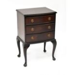 A small reproduction bow-fronted three-drawer bedside chest raised on cabriole legs, height 69cm,