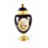 A Coalport lidded vase hand painted with a cartouche depicting Loch Lomond by E O Ball, signed,