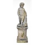 A reconstituted stone garden statue of a boy holding a cornucopia of fruit,
