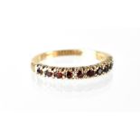A 9ct gold and ruby half eternity ring, set with ten small rubies, size Q, approx 2.6g.