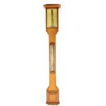 A 20th century oak stick barometer with ivorine face and a silvered thermometer mounted to the