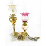 A Victorian brass oil lamp with later moulded and printed shade,