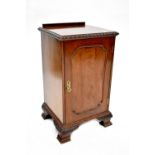 A 19th century style mahogany bedside cupboard with single door on carved ogee bracket feet,