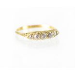 An 18ct yellow gold ring set with five small diamonds, size P1/2, approx 2.6g (marks rubbed).