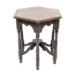 A 19th century Phillips of Bristol oak hexagonal centre table, carved frieze on six turned supports,