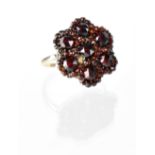 A late 19th century yellow metal and ruby flower head cluster ring,