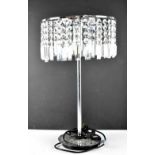 A modern table lamp with cut glass drops, on a chrome base, height 57cm.