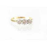 A Boodle & Dunthorne 18ct yellow gold and platinum three-stone diamond ring, size T, approx 2.7g.