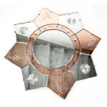An Art Deco peach and clear glass mirror of octagonal star form with cut flower head and