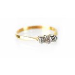An 18ct gold and platinum small three-stone diamond ring, size O, approx 2.3g.