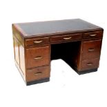 A mid-20th century mahogany kneehole desk, three frieze drawers above two larger drawers,
