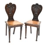 A pair of Victorian oak hall chairs, heart-shaped back with shell,