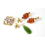 A 9ct gold brooch with amethyst and pearl flower on open scroll mount,