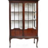 An Edwardian mahogany twin-door display cabinet, astragal glazed doors, two interior shelves,