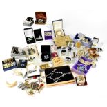 A large quantity of costume jewellery to include brooches, necklaces, faux pearls,