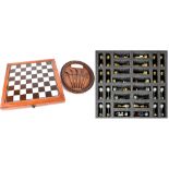 A mahogany-cased set of golfing themed chess pieces and an oval wall plaque depicting antique golf