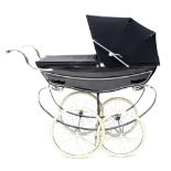 A black and chrome Silver Cross pram of typical form with folding hood and cover,