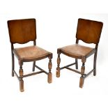 A set of four 1930s oak dining chairs with veneered backs and leatherette upholstered seats (4).