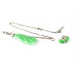 A 9ct white gold jade-set pendant and a pair of oval jade stud earrings.