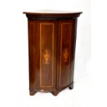 A 19th century mahogany inlaid bow-front wall-hanging corner cupboard with urn and swag inlay to