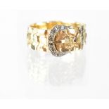 A vintage 9ct gold buckle ring, the white gold buckle inset with tiny diamonds and two small rubies,